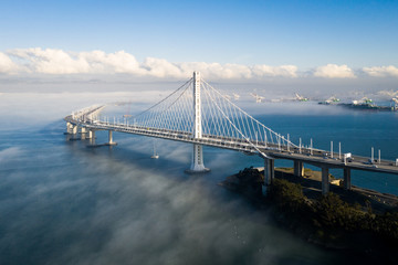 San Francisco - Oakland Bay Bridge East Span With Low Fog in Background - obrazy, fototapety, plakaty