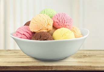 Ice cream scoops in bowl on white background