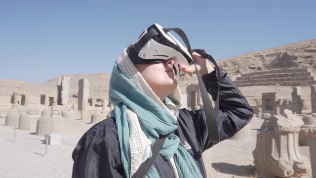 Tourist looking 3D reconstruction of Persepolis with VR headset