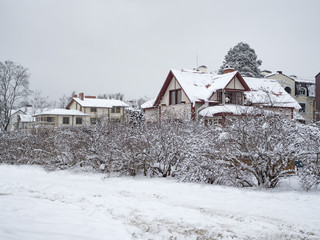 Snow-covered houses. A lot of snow in the winter in the village.
