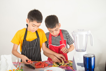Little boys blend water melone juice by using blender at home