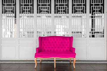Pink vintage sofa with white chinese door background