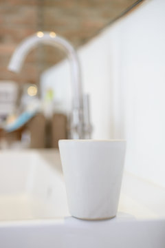white ceramic cups in blurred bathroom background