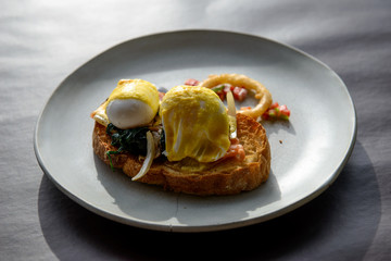 Poached egg with hollandaise sauce on toast with salmon ham and spinach