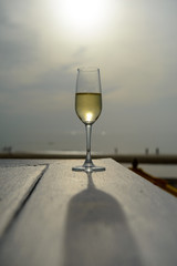 champagne glass with blurred sea and sky background