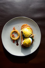 Poached egg with hollandaise sauce on toast with salmon ham and spinach