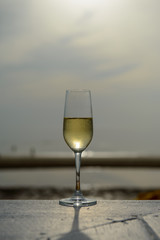 champagne glass with blurred sea and sky background