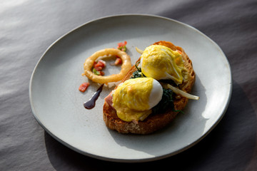 Poached egg with hollandaise sauce on toast with salmon ham and spinach