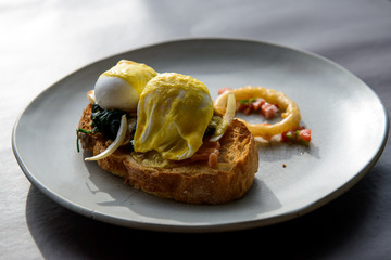 Poached egg with hollandaise sauce on toast with salmon ham and spinach