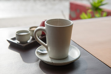 Hot tea served in a mug with milk and sugar