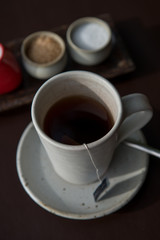 Hot tea served in a mug with milk and sugar