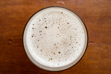 Glass of beer top view with beautiful beer bubbles texture