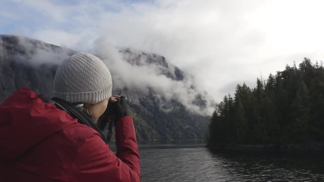 Alaska tourist photographer enjoying travel vacation cruise in Misty Fiords National Monument (aka Misty Fjords) taking pictures photographing the travel adventure in Alaska.