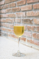 champagne glass with blurred brick background