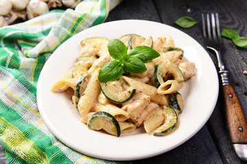 Penne pasta witch chicken and zucchini in cheese sauce