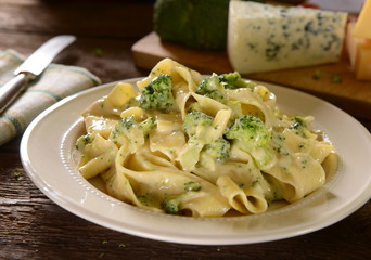 Tagliatelle pasta with cheese sauce and broccoli