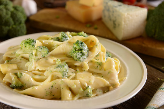 Tagliatelle pasta with cheese sauce and broccoli - Powered by Adobe
