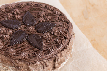 Chocolate cake top view on wooden background table. Sweet dessert.