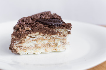 Slice of chocolate cake on white plate. Sweet dessert.