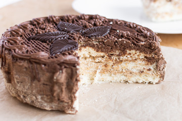 Chocolate cut cake top view on wooden background table. Sweet dessert.