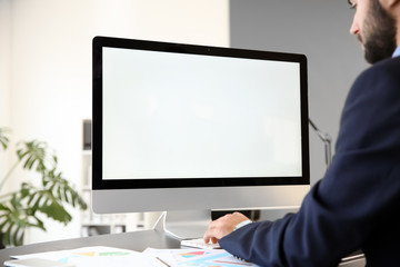 Young businessman working on computer in office