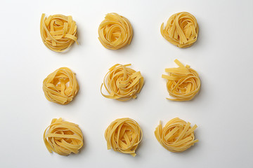 Uncooked noodles on white background