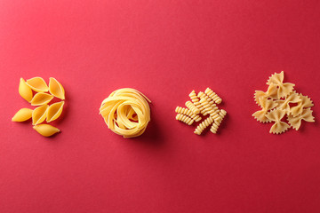 Fototapeta na wymiar Assortment of uncooked pasta on color background