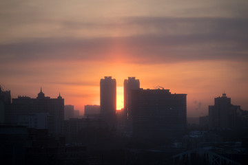 dawn in the city in smog