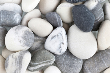 Fototapeta na wymiar Sea stones are white and gray. Background