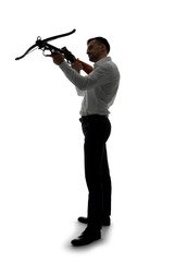 Portrait of young businessman with crossbow on white background