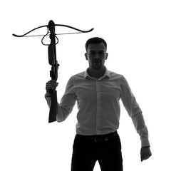 Portrait of young businessman with crossbow on white background