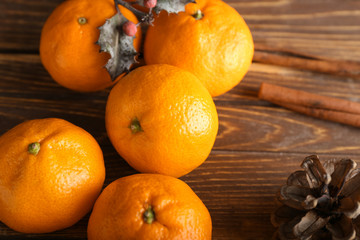 Ripe sweet tangerines on wooden background