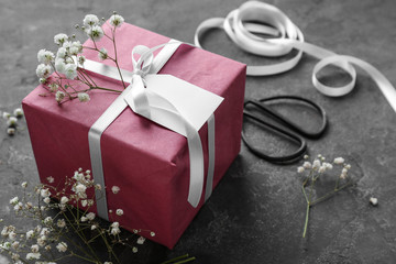 Festive gift box on grey table