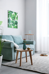 Stylish interior of living room with comfortable sofa