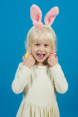 Little girl in bunny ears, easter. Child smile with handmade eggs. punchy pastel trend. Kid beauty and fashion look. Happy easter day. Spring holidays celebration