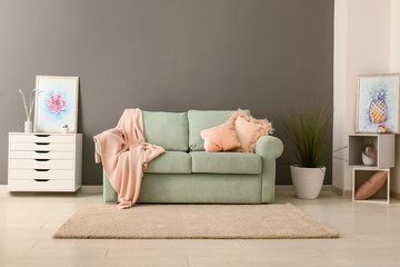 Stylish interior of living room with comfortable sofa