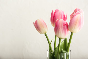 Bouquet of beautiful tulips on light background