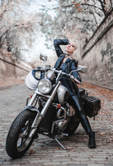 Fototapeta na wymiar Beautiful biker woman outdoor with motorcycle. 