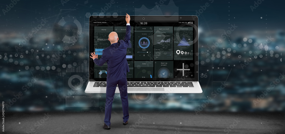 Poster businessman in front of a wall with laptop with business user interface data on the screen isolated 