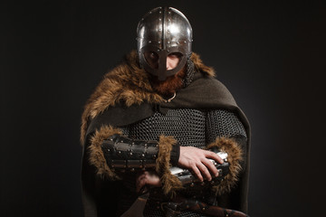 Warrior Viking in full arms with axe on dark background