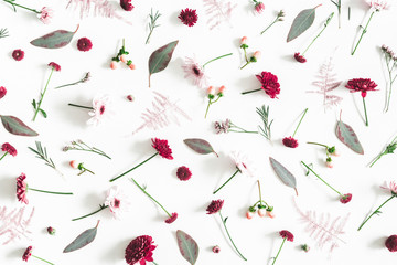 Flowers composition. Eucalyptus leaves and pink flowers on white background. Flat lay, top view