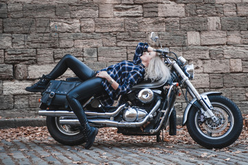Plakat Beautiful biker woman outdoor with motorcycle. 