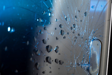 Broken smartphone screen, cracks and shattered glass under various eels