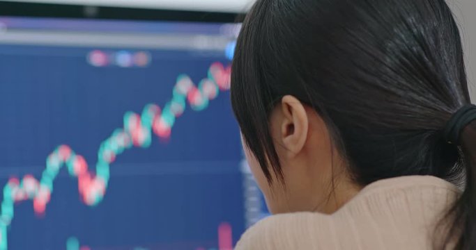 Woman look at the stock market graph