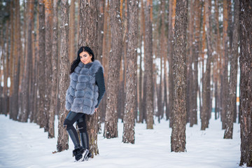 Naklejka premium Elegant and casual female beauty. Attractive lady in grey fur coat, nice girl in park, lifestyle of woman, pretty arabic face 