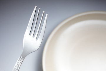 fork and knife on white plate