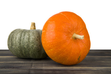 raw pumpkin on wooden table isolated on white background