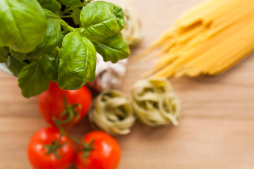 Italian pasta food on wooden background. Garlic, Tomatoes, Basil, Spicy