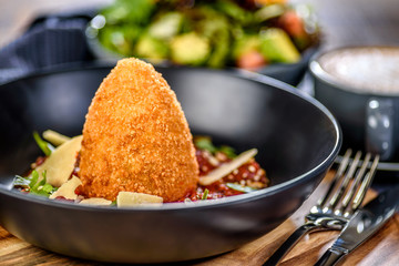 A serving of traditional Italian Arancini with Parmesan cheese
