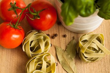 Italian pasta food on wooden background. Garlic, Tomatoes, Basil, Spicy